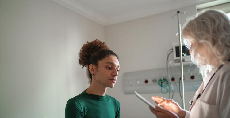 A photo of a person speaking to a GP