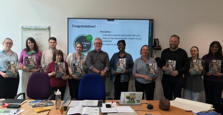 A photo of a row of people holding what appear to be certificates.