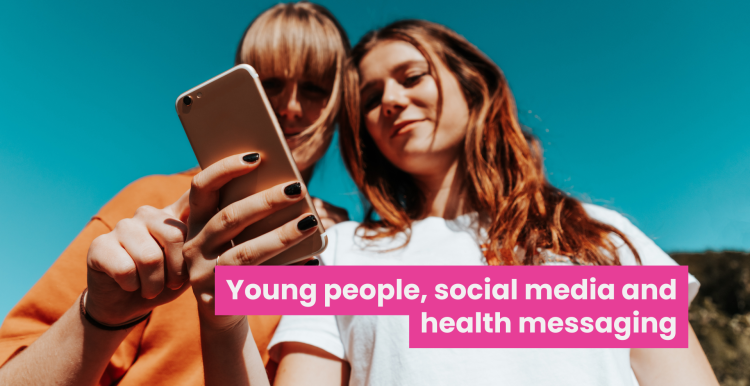 A photo of two young women looking at something on a phone together. Bold text across the image reads 'Young people, social media and health messaging'