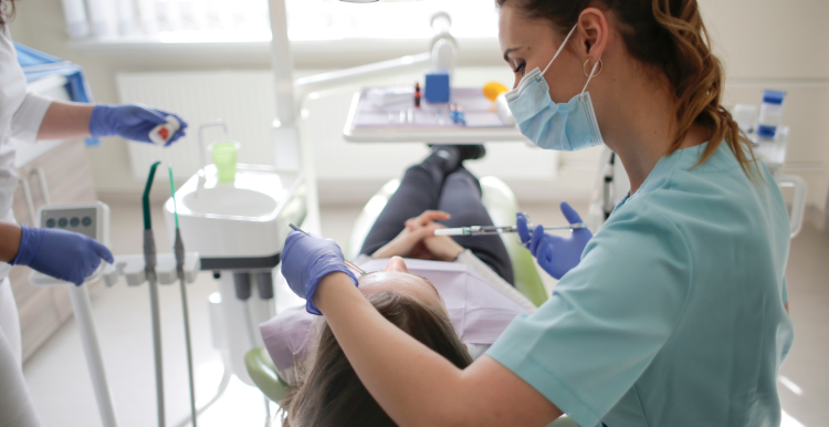 A photo of a dentist with a patient