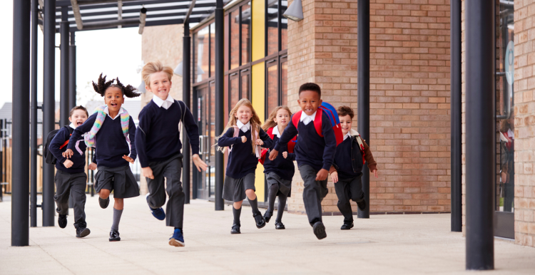 A photo of primary school aged children running