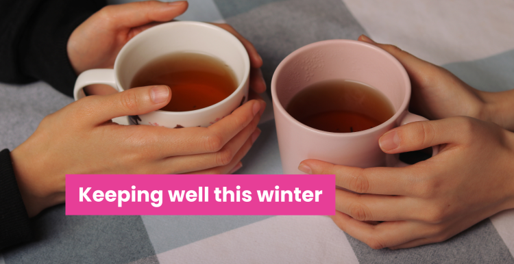A photo of two mugs on a table with hands clasped around them. Text reads 'keeping well this winter'