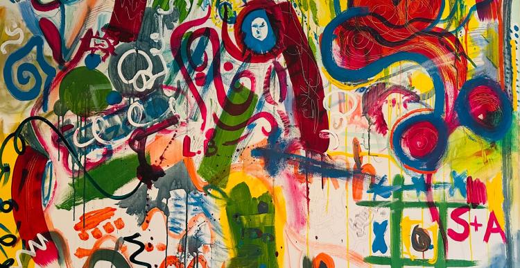 A photo of a canvas that has been expressively painted with bright colours and shapes.