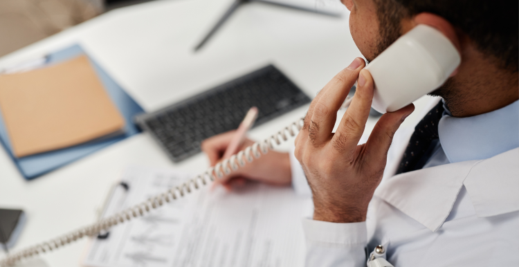 A photo of a doctor on the phone