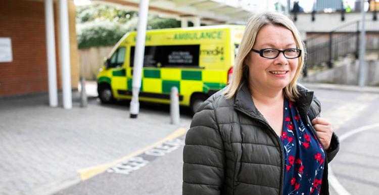 Woman in front of ambulance