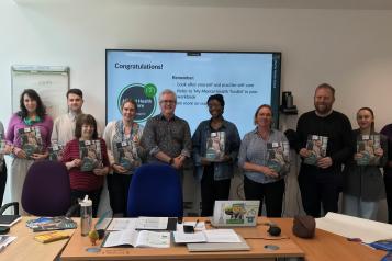 A photo of a row of people holding what appear to be certificates. 