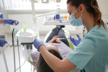 A photo of a dentist with a patient