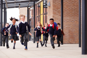 A photo of primary school aged children running