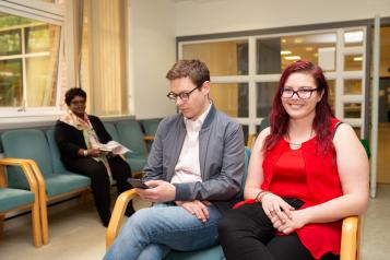 Two people sitting in a waiting room