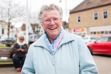 Elderly woman smiling face on to the camera