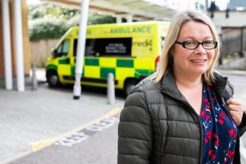 Woman in front of ambulance