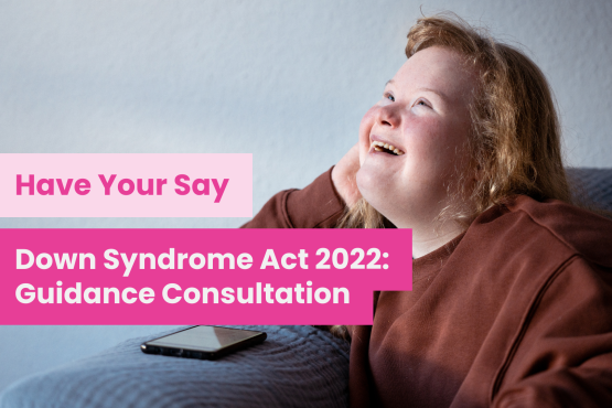 A photo of a young woman with Down syndrome, she is sitting on a sofa looking away from the camera and smiling. Overlaid text reads 'Have your say: Down syndrome Act 2022: Guidance Consultation'