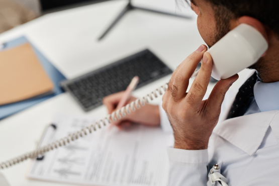 A photo of a doctor on the phone
