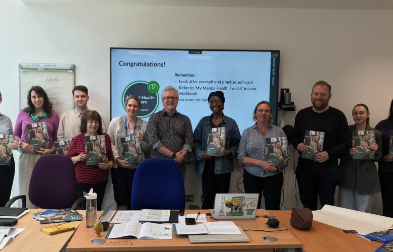A photo of a row of people holding what appear to be certificates.