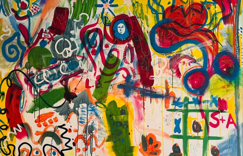 A photo of a canvas that has been expressively painted with bright colours and shapes.